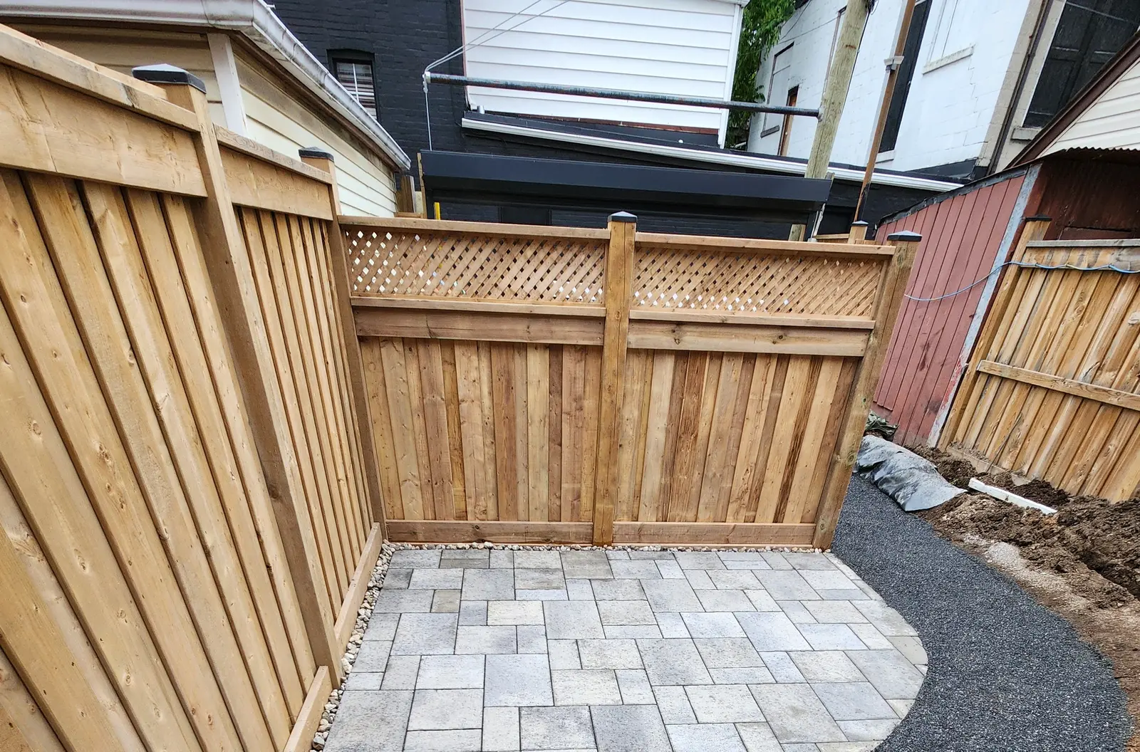 Cedar fence extension with lattice top & paver pad