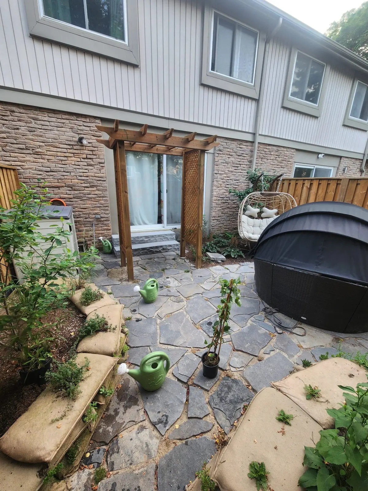 Flagstone patio with pergola & stone veneer accent wall