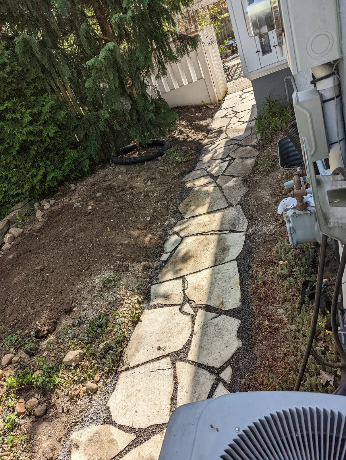 Flagstone side walkway along house foundation