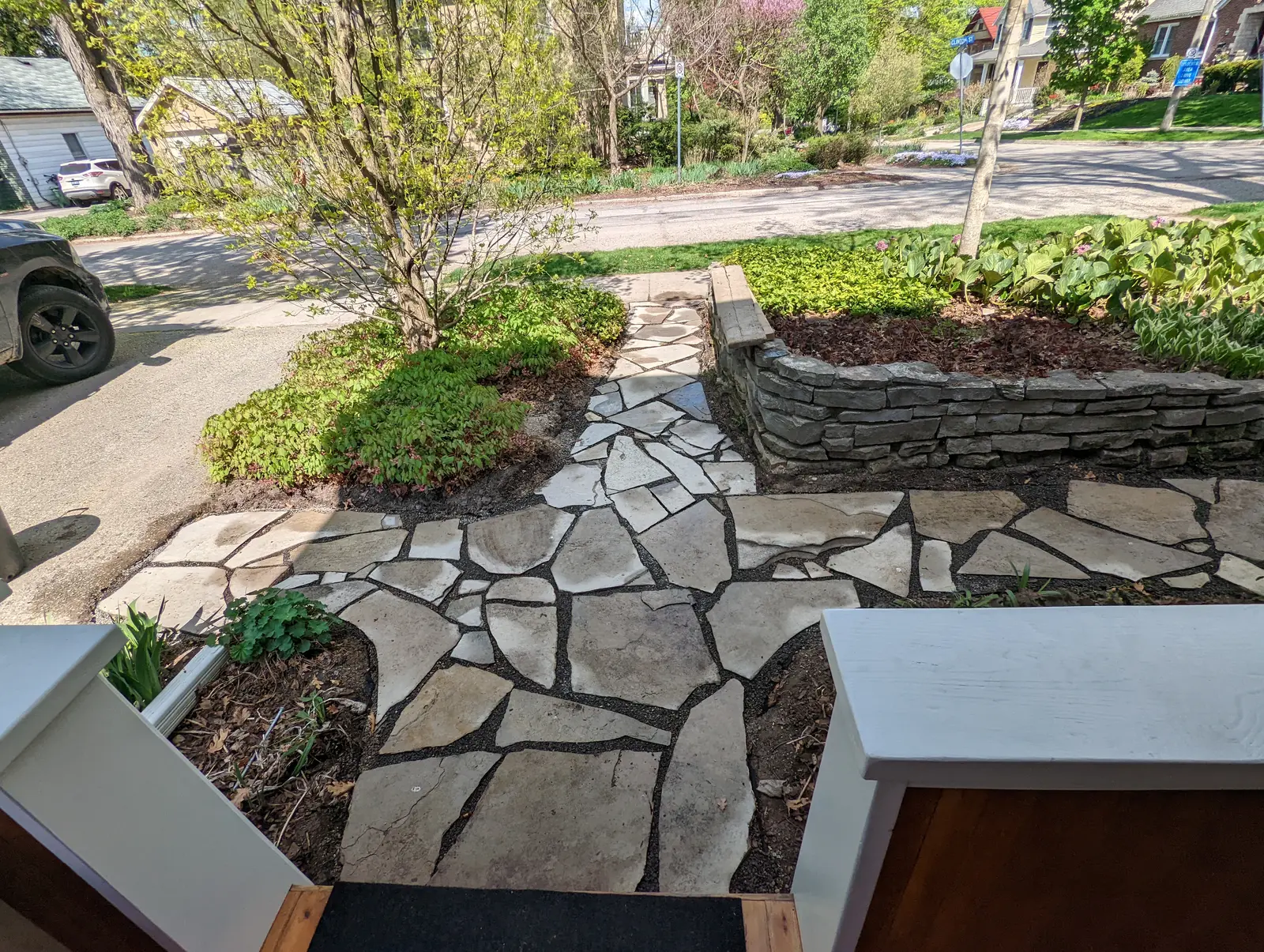 Flagstone front entry with stone retaining wall & garden