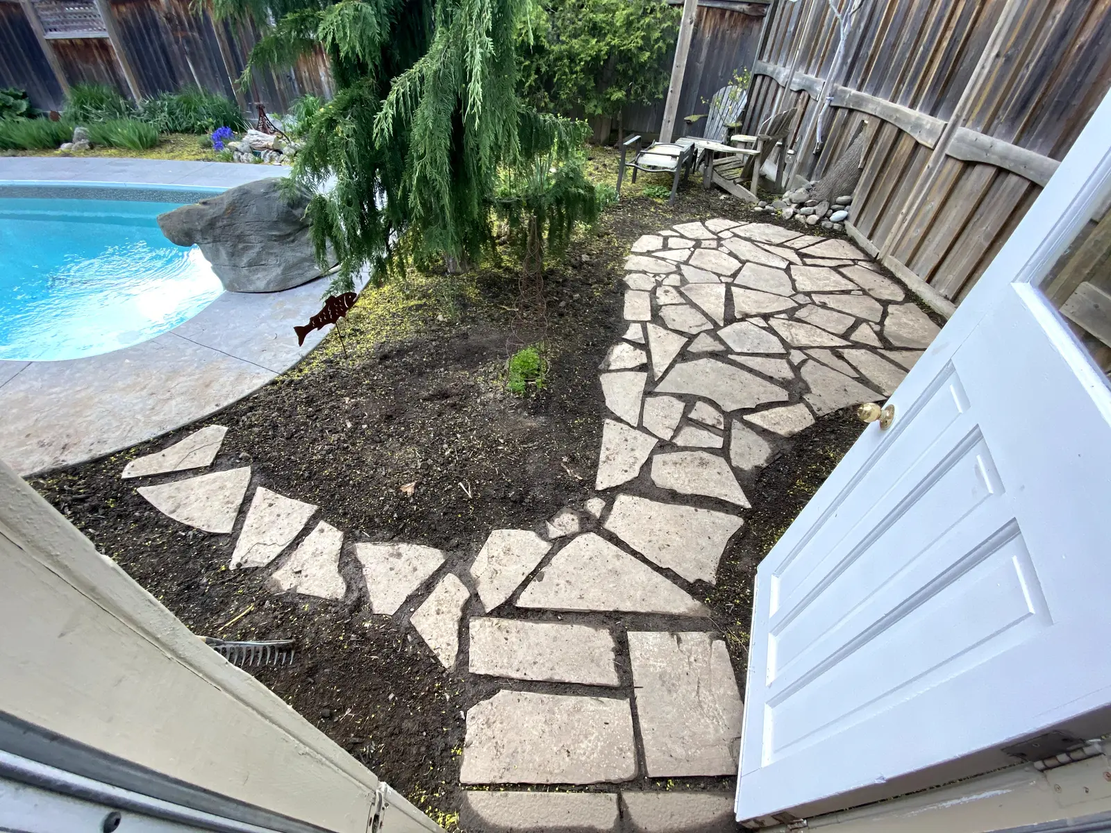 Flagstone pathway leading to poolside seating area