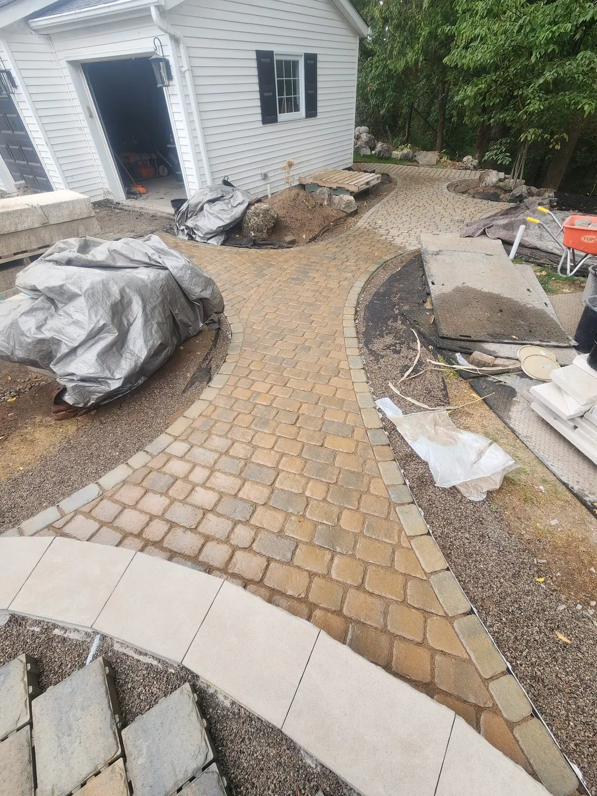 Curved tumbled paver walkway & front entrance in progress