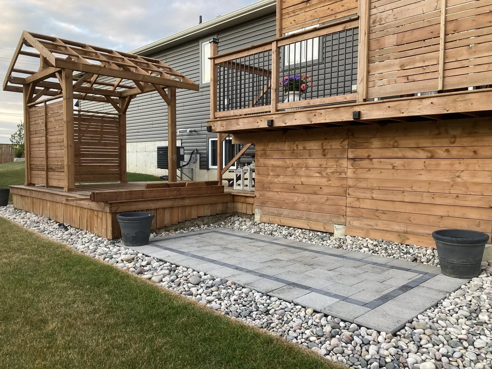 Paver landing pad with cedar pergola & raised deck