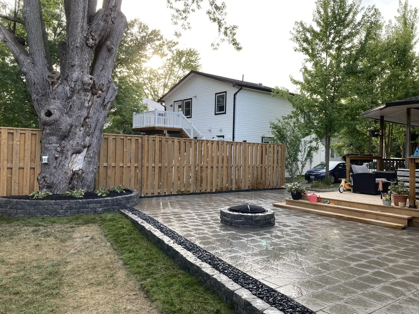 Backyard paver patio with fire pit & retaining wall planter
