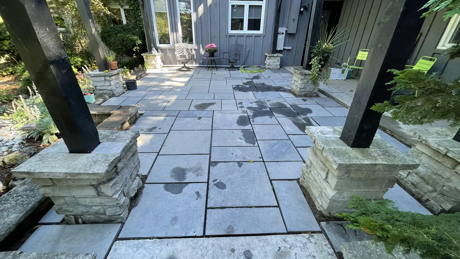 Natural stone slab patio with armour stone pillar bases