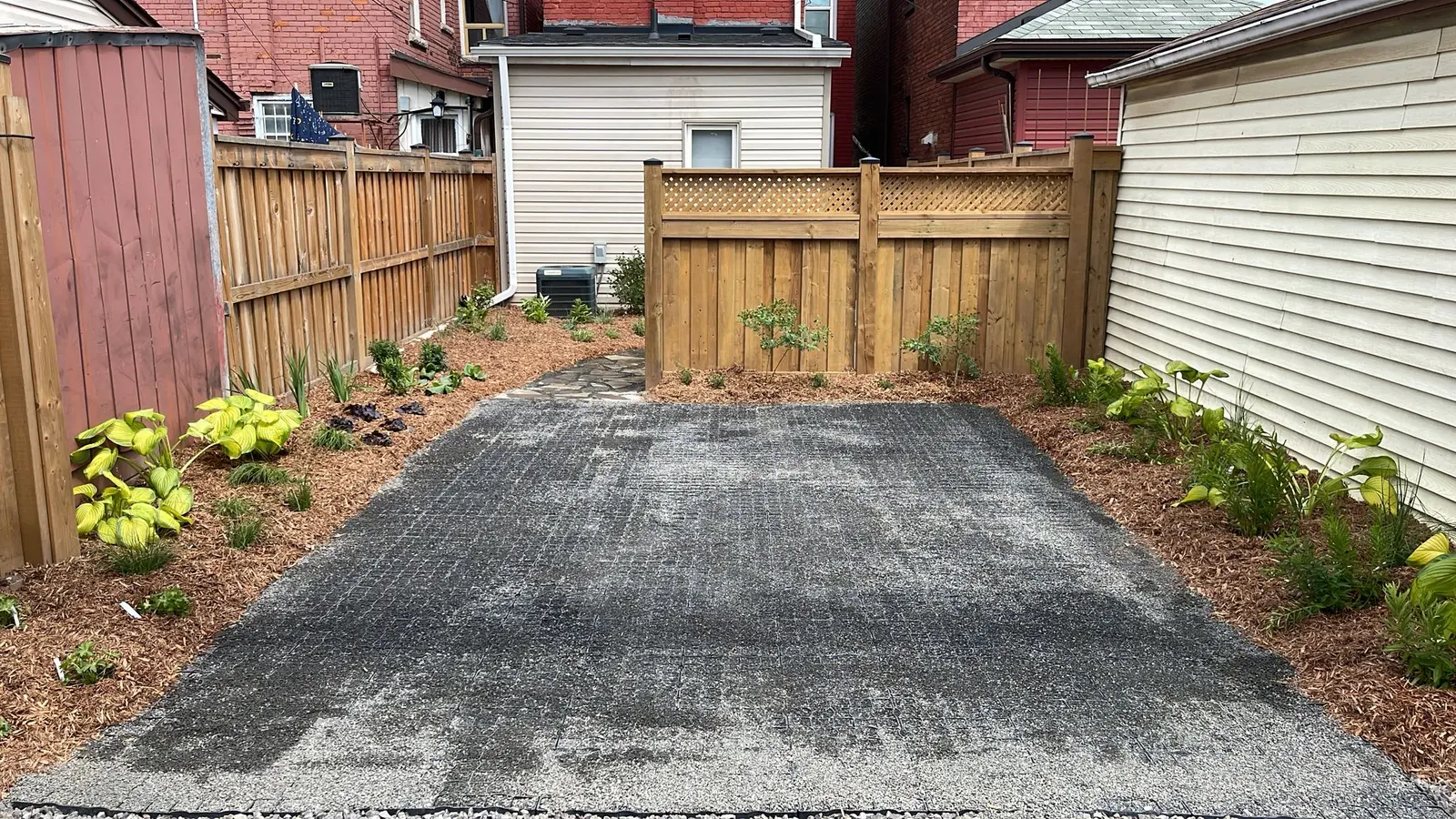 New backyard pollinator bed with fresh mulch & young native plants