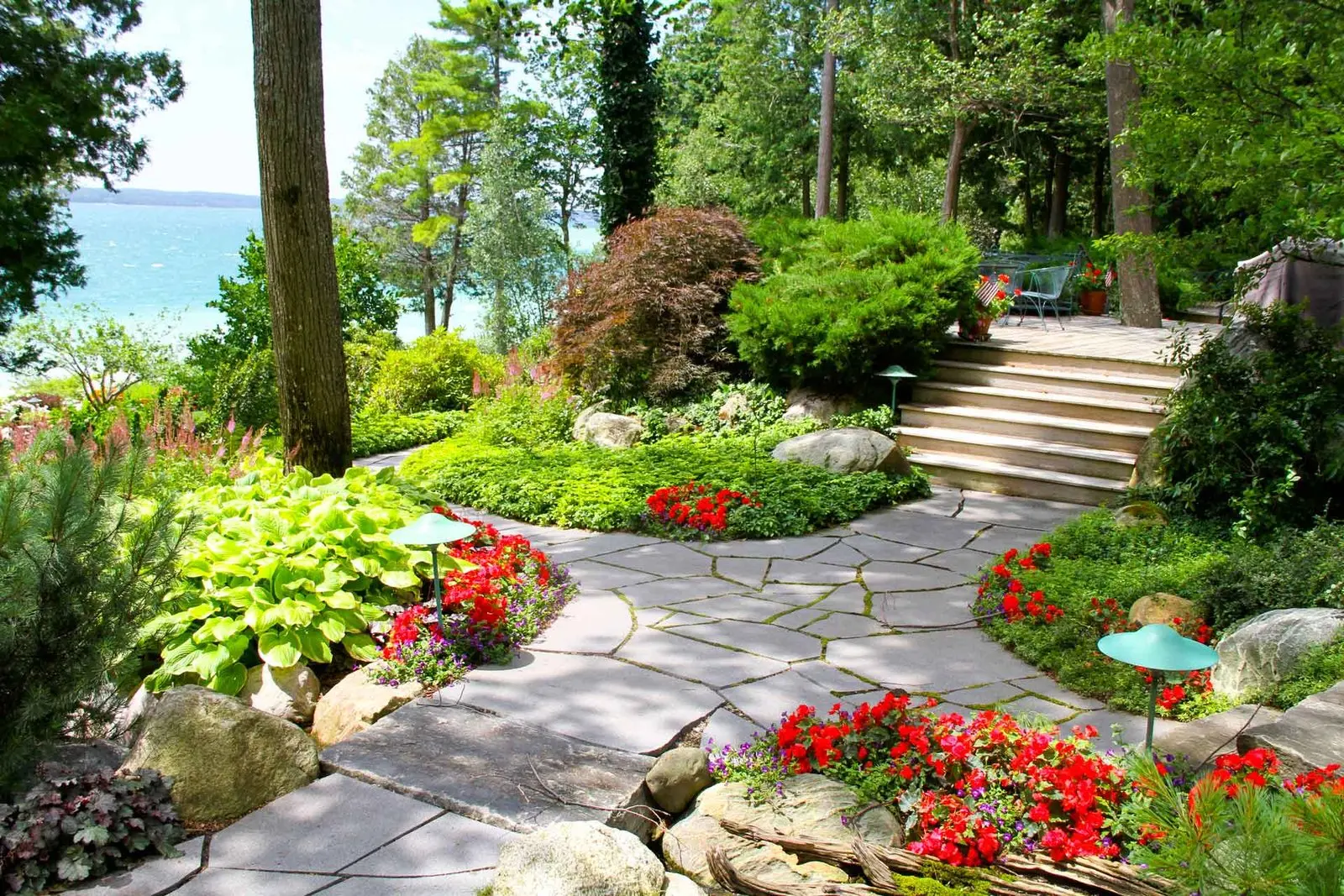 Lakeside flagstone walkway with hostas, impatiens & boulder accents