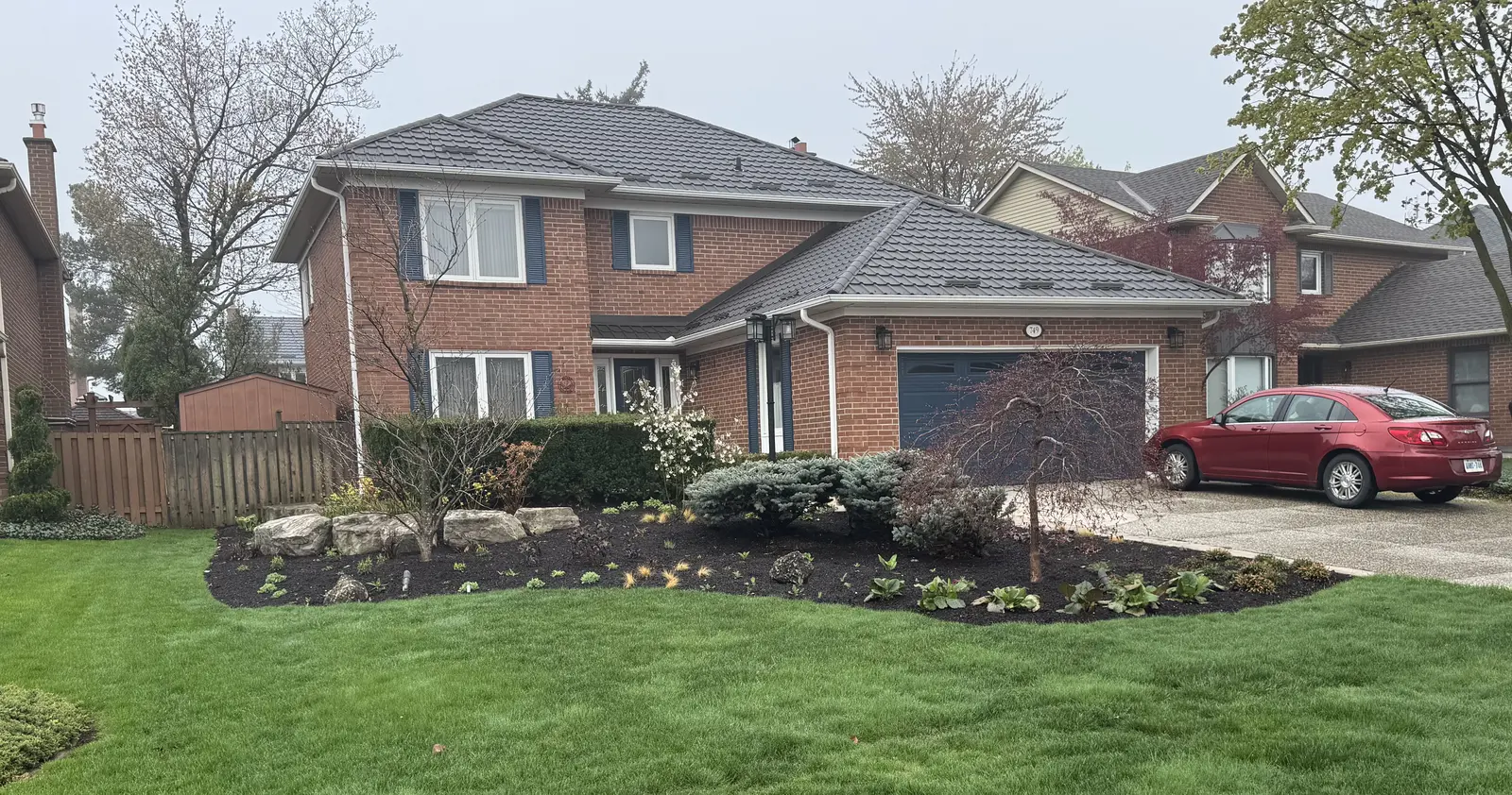 New front yard pollinator bed installation with fresh plantings
