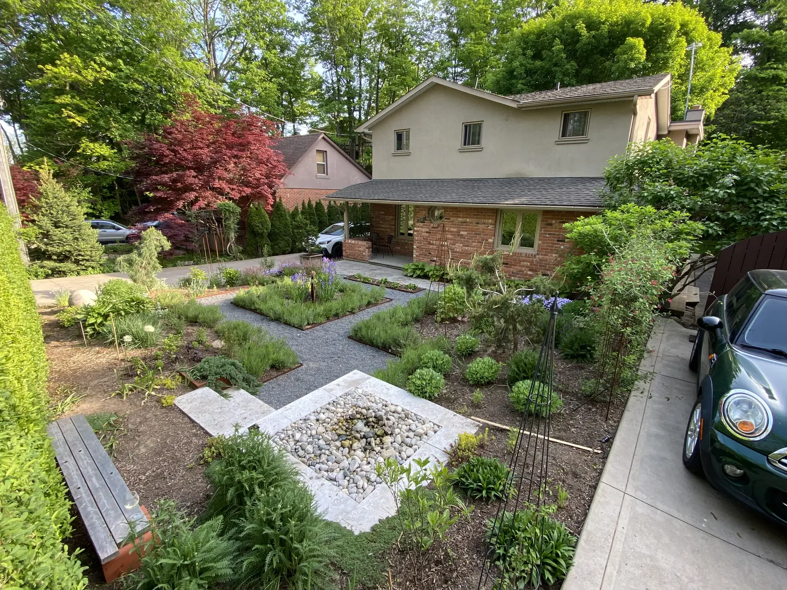 Lawn-free front yard with gravel paths, pollinator beds & rock basin