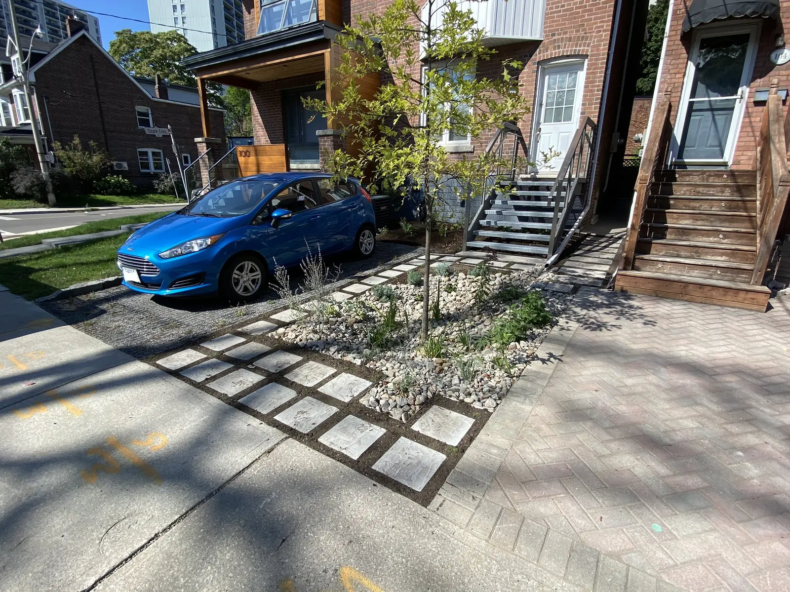 Urban front yard rain garden with permeable pavers & young tree