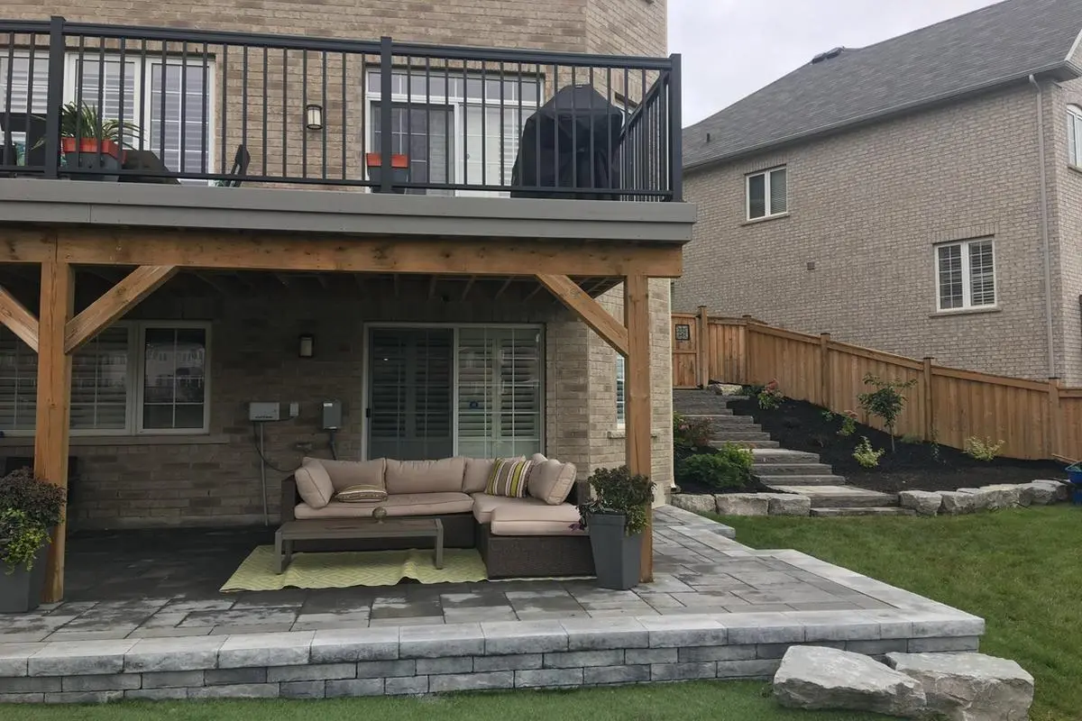 Paver patio with block retaining wall, stone steps & under-deck lounge area
