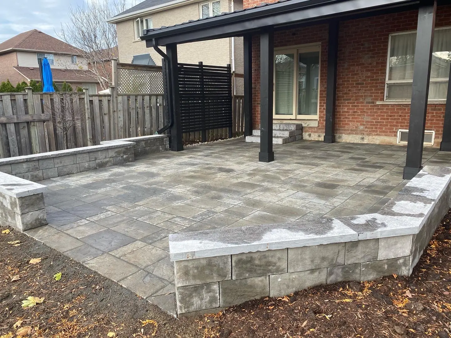 Raised paver patio with block retaining wall & covered pergola