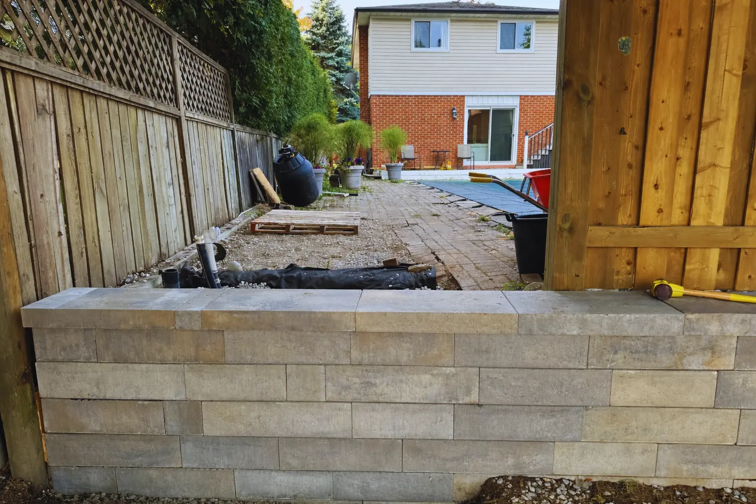 Block retaining wall repair & paver walkway restoration in progress