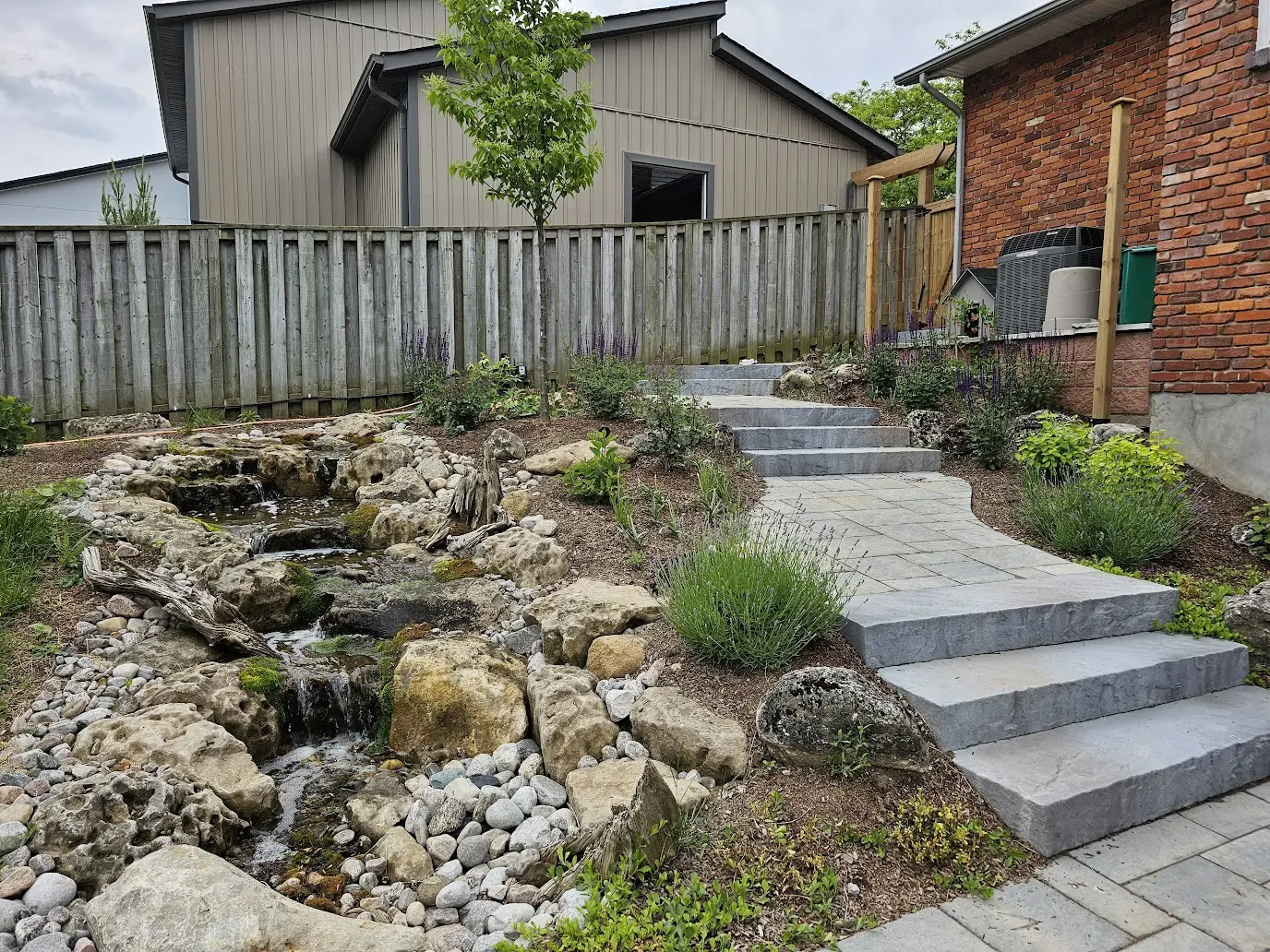 Pondless waterfall with natural stone & flagstone steps